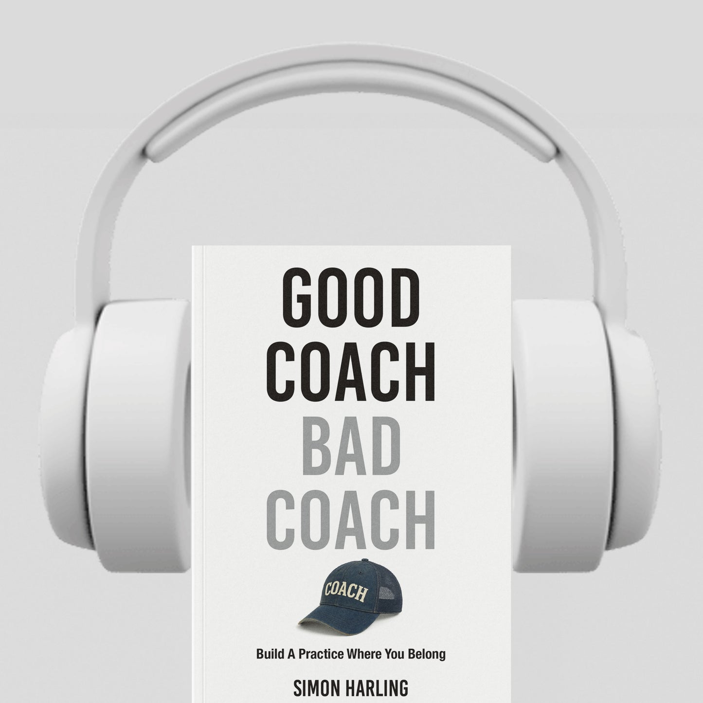 White headphones with a book titled 'Good Coach Bad Coach' by Simon Harling on a light gray background