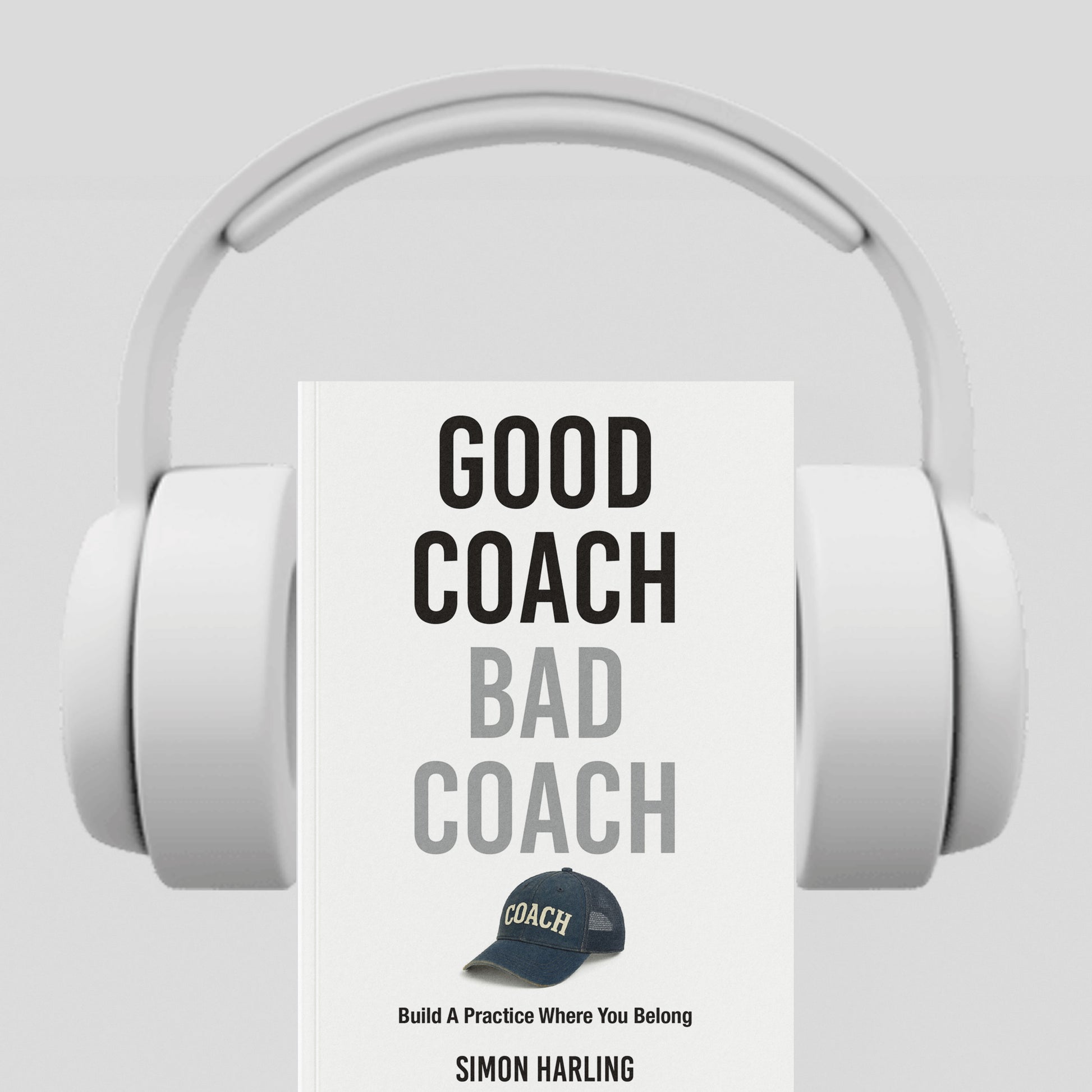 White headphones with a book titled 'Good Coach Bad Coach' by Simon Harling on a light gray background